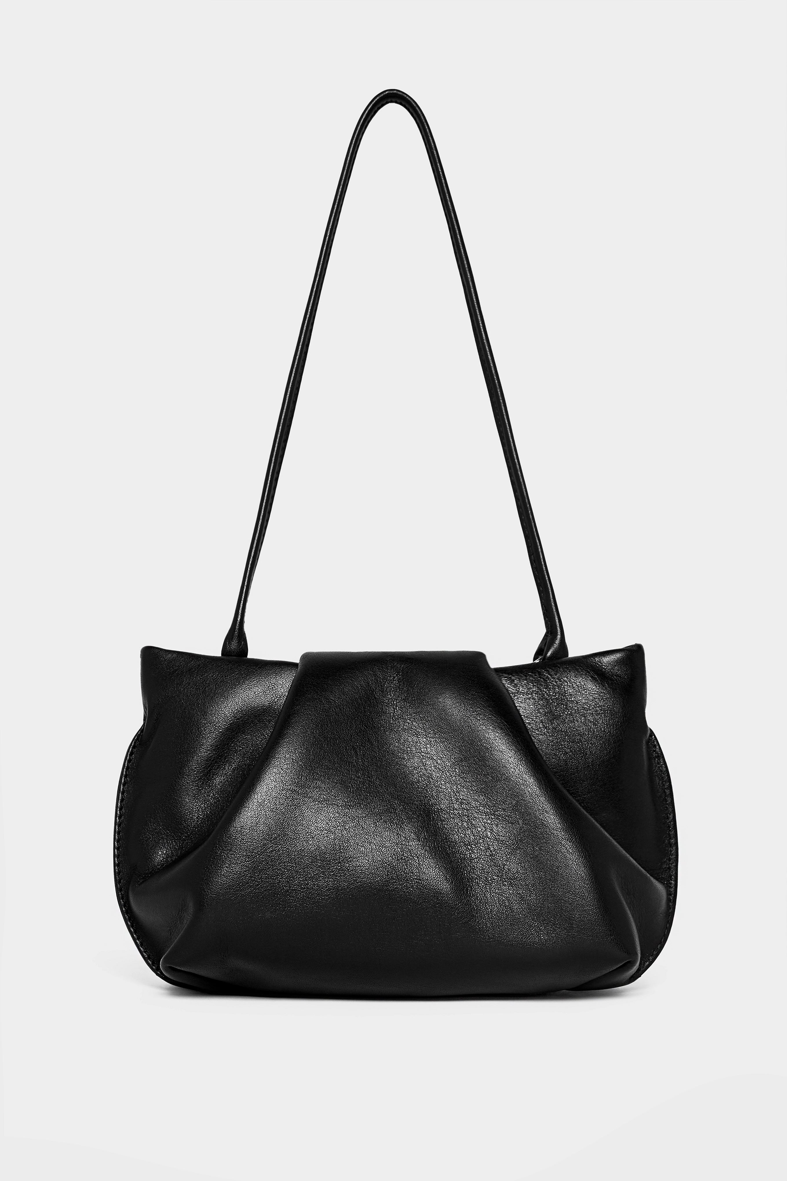 A photo of the black fold mini clutch bag with its handles up. It functions both as as a shoulder bag and a clutch or purse.