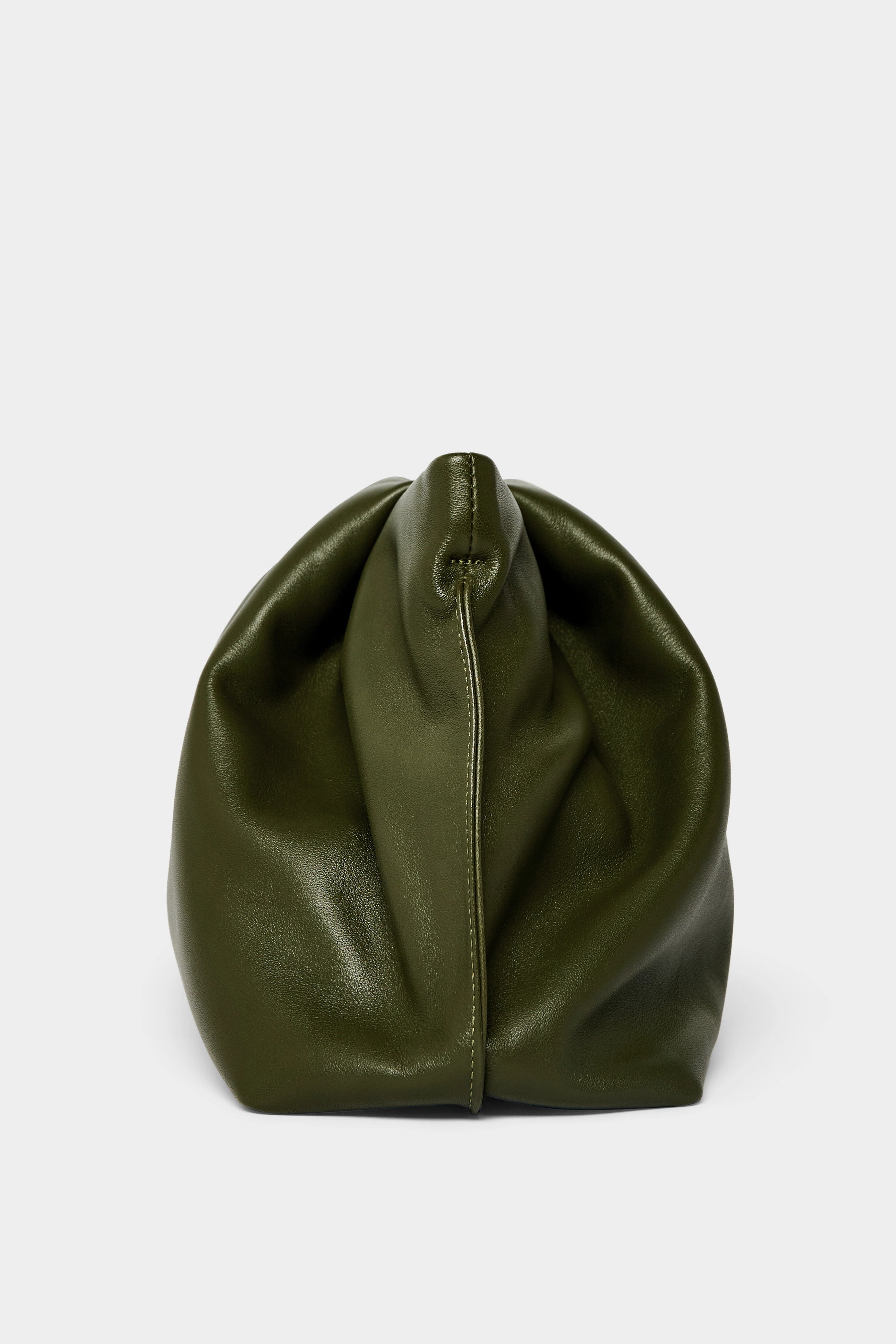 A side angle of the Fold clutch purse features delicate hand stitching of the handbag.