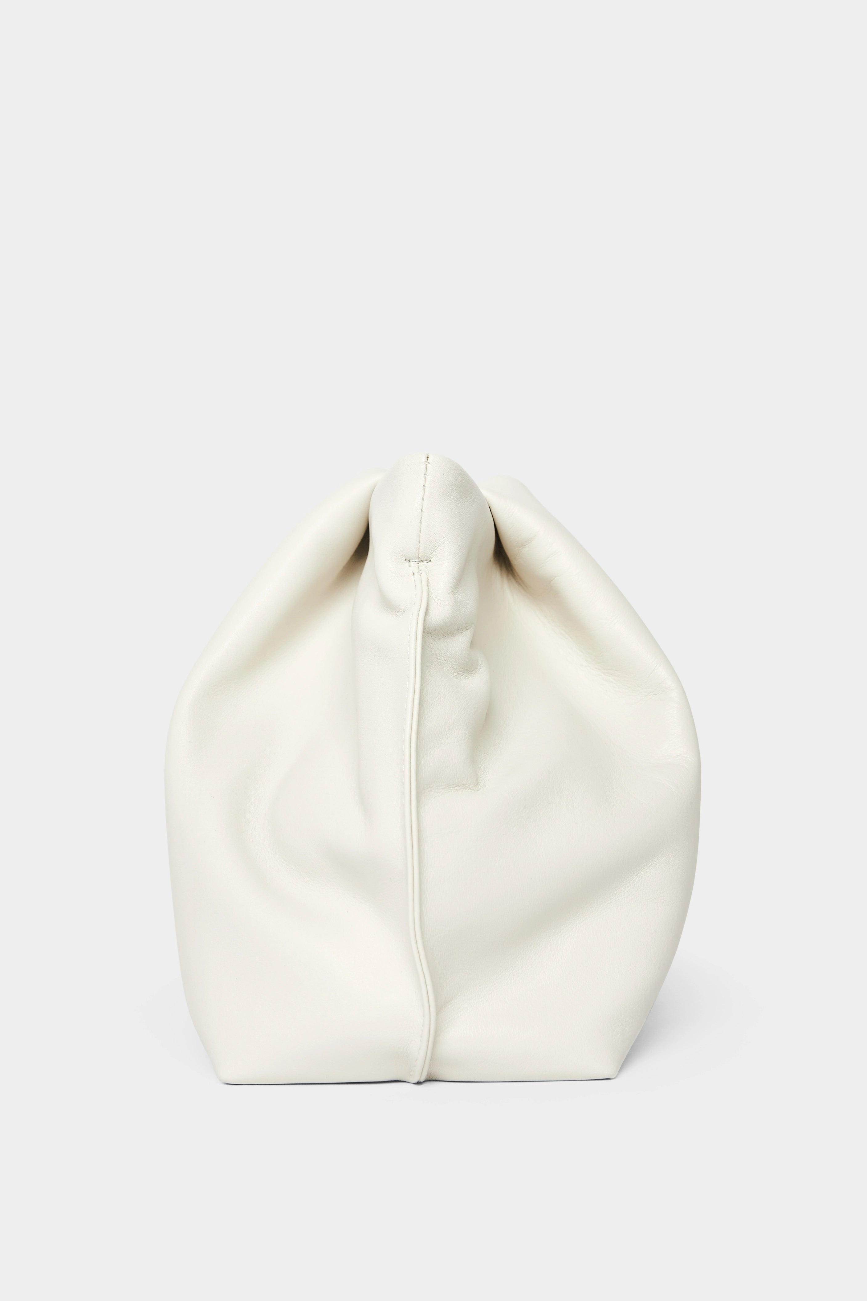 A side angle of the Fold clutch purse features delicate hand stitching of the handbag.