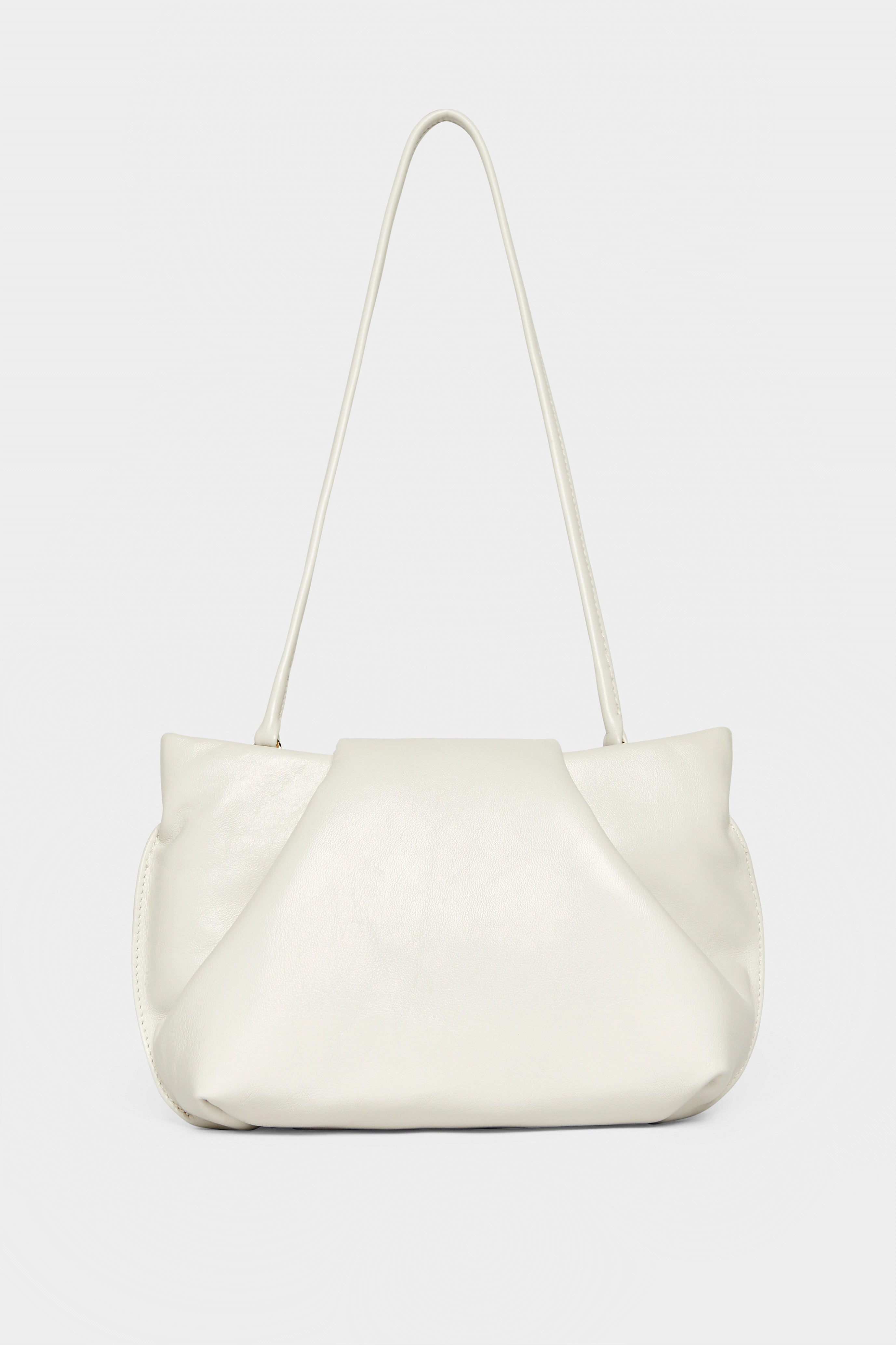 A photo of the off white fold mini clutch bag with its handles up. It functions both as as a shoulder bag and a clutch or purse.