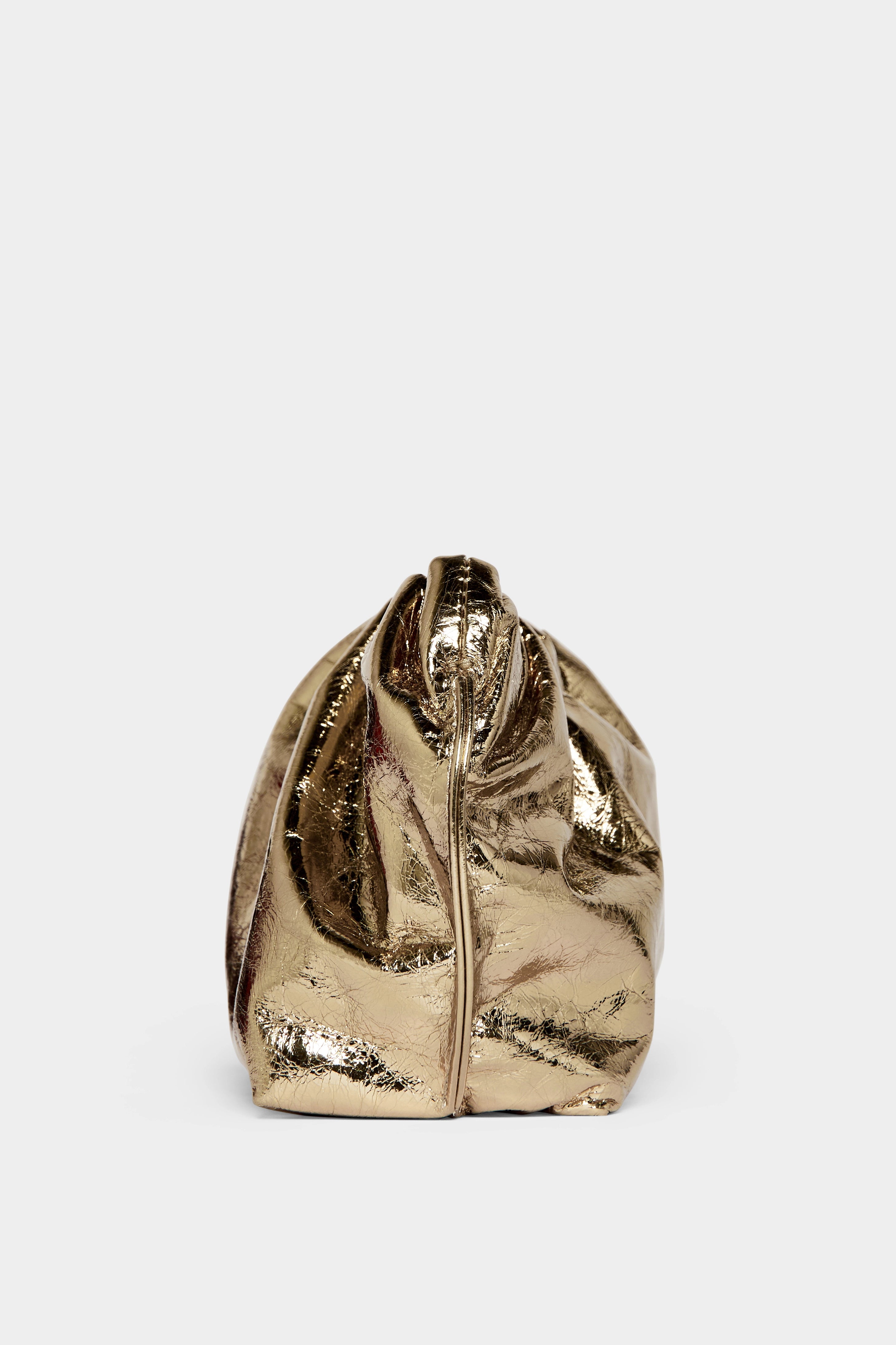 A side angle of the mini Puffa clutch purse featuring a delicate hand stitching of the mini bag's sides.