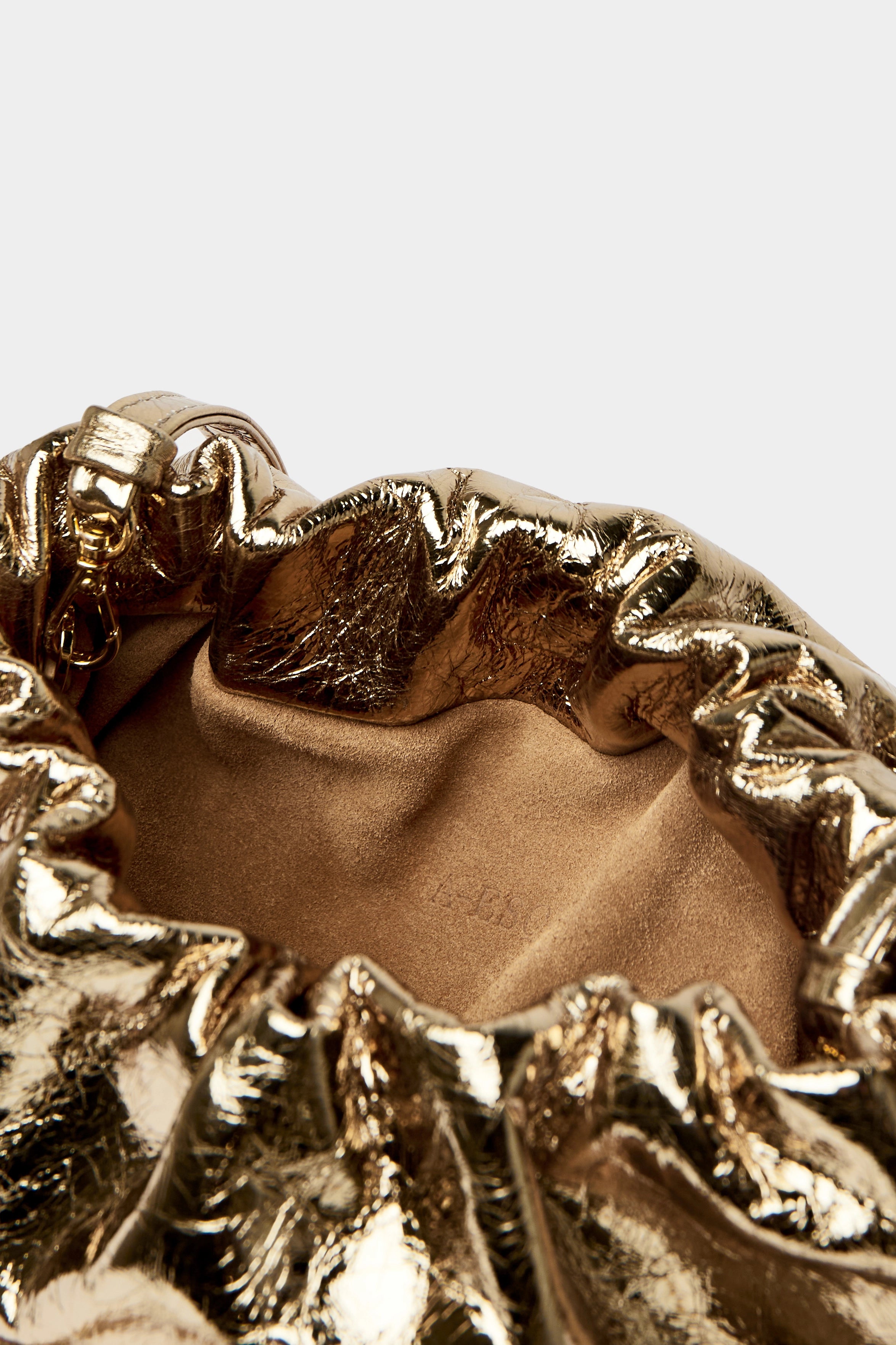 Mini Puffa crossbody bag has a suede interior lining with an A-esque logo stamped in the middle.