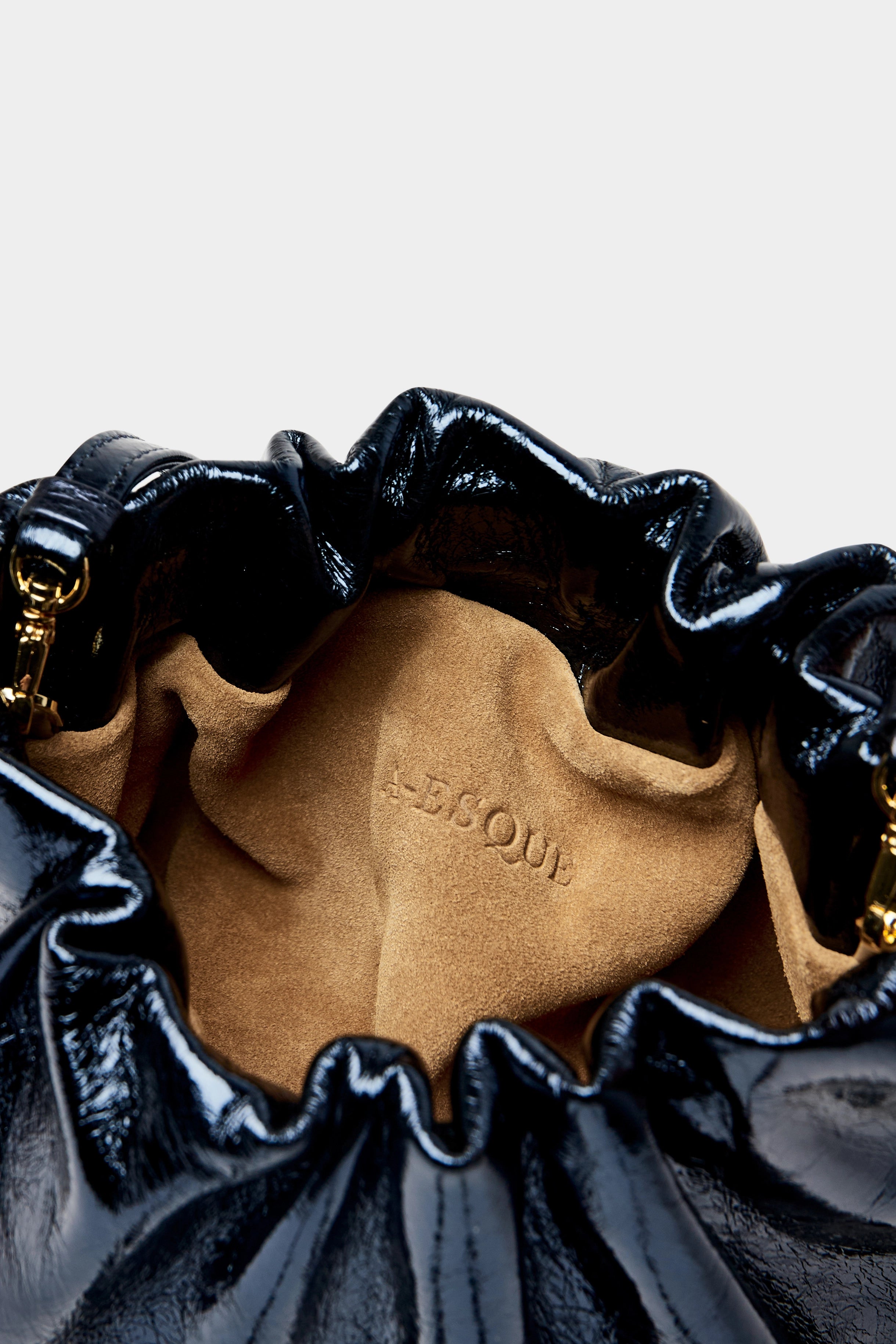 Mini Puffa crossbody bag has a suede interior lining with an A-esque logo stamped in the middle.