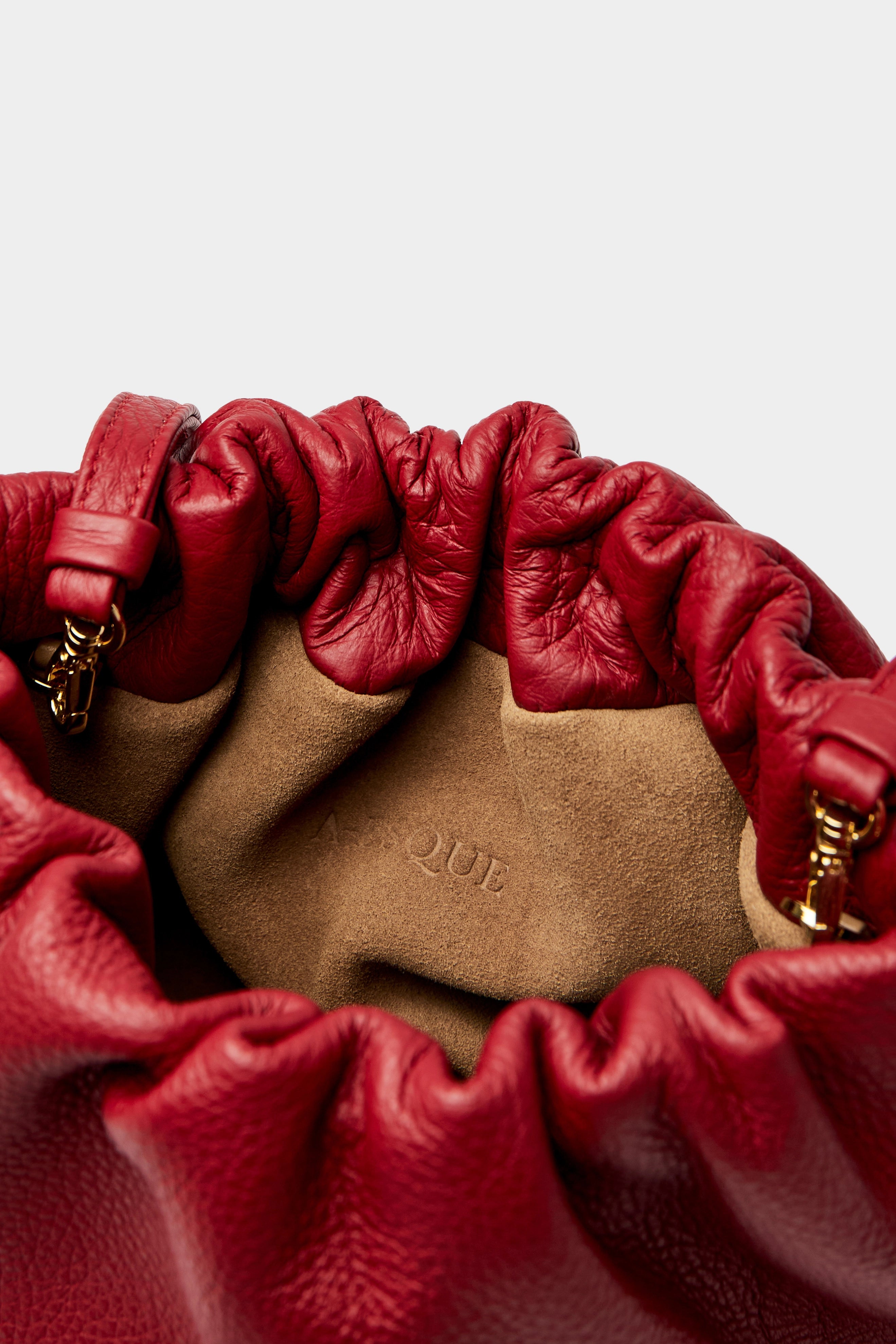 Mini Puffa crossbody bag has a suede interior lining with an A-esque logo stamped in the middle.