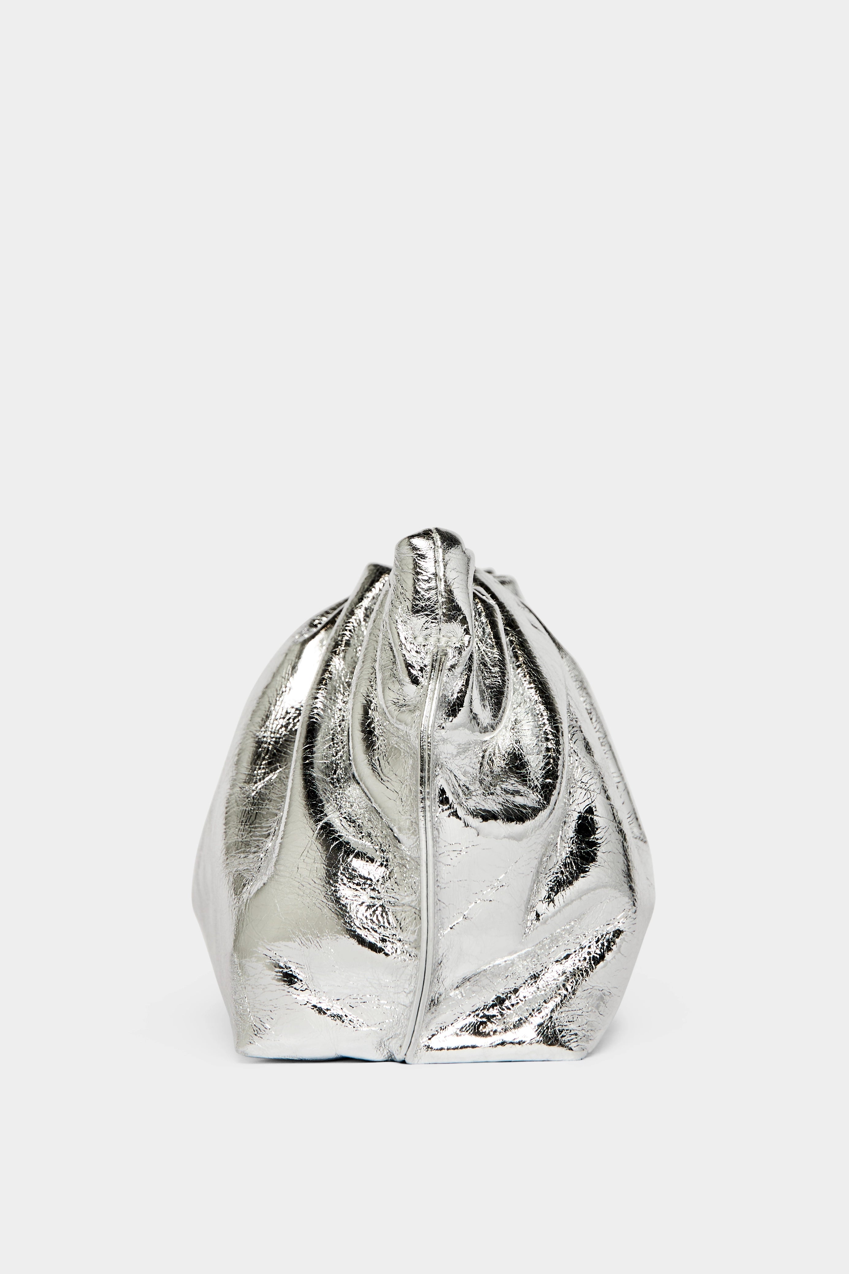 A side angle of the mini Puffa clutch purse featuring a delicate hand stitching of the mini bag's sides.