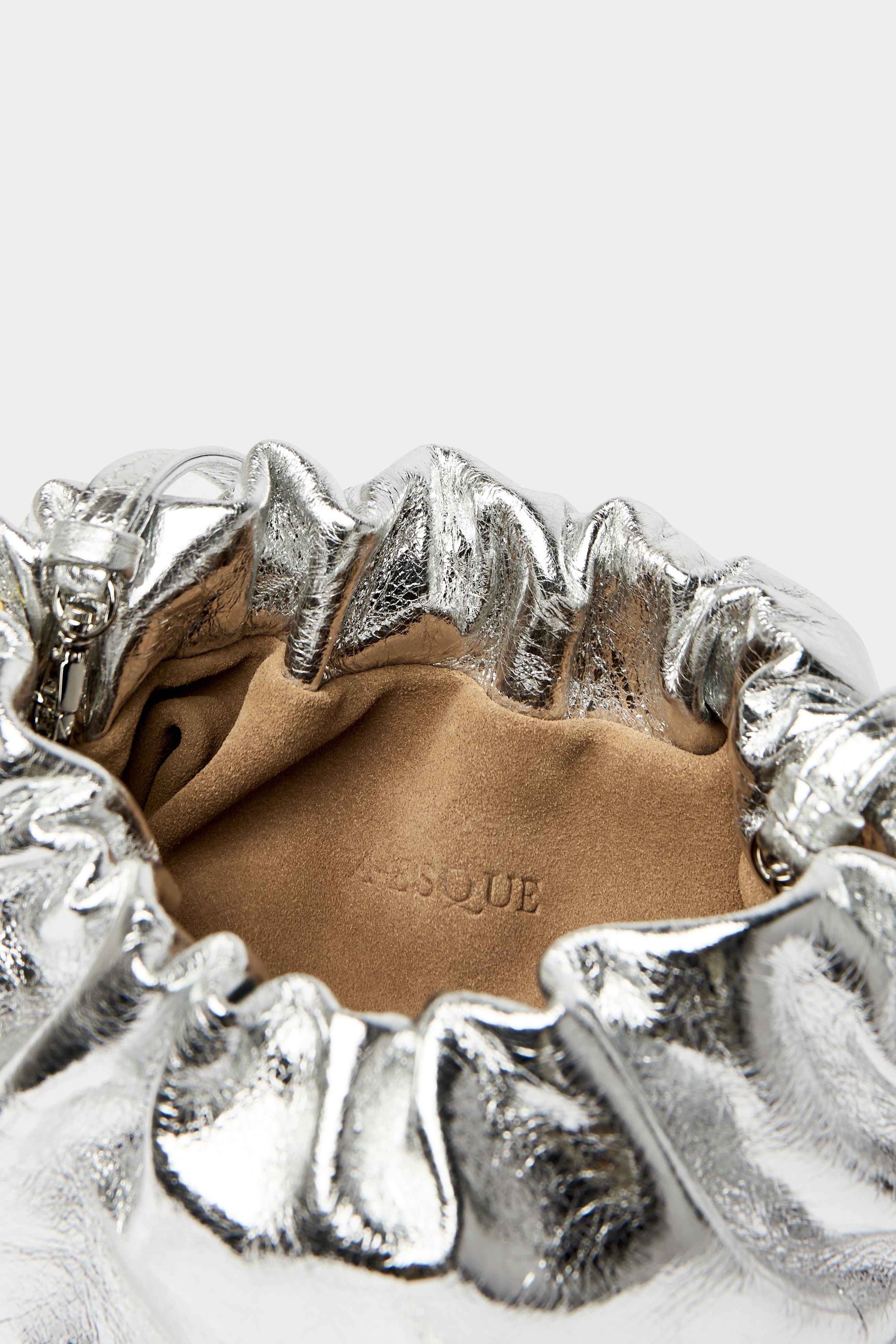 Mini Puffa crossbody bag has a suede interior lining with an A-esque logo stamped in the middle.