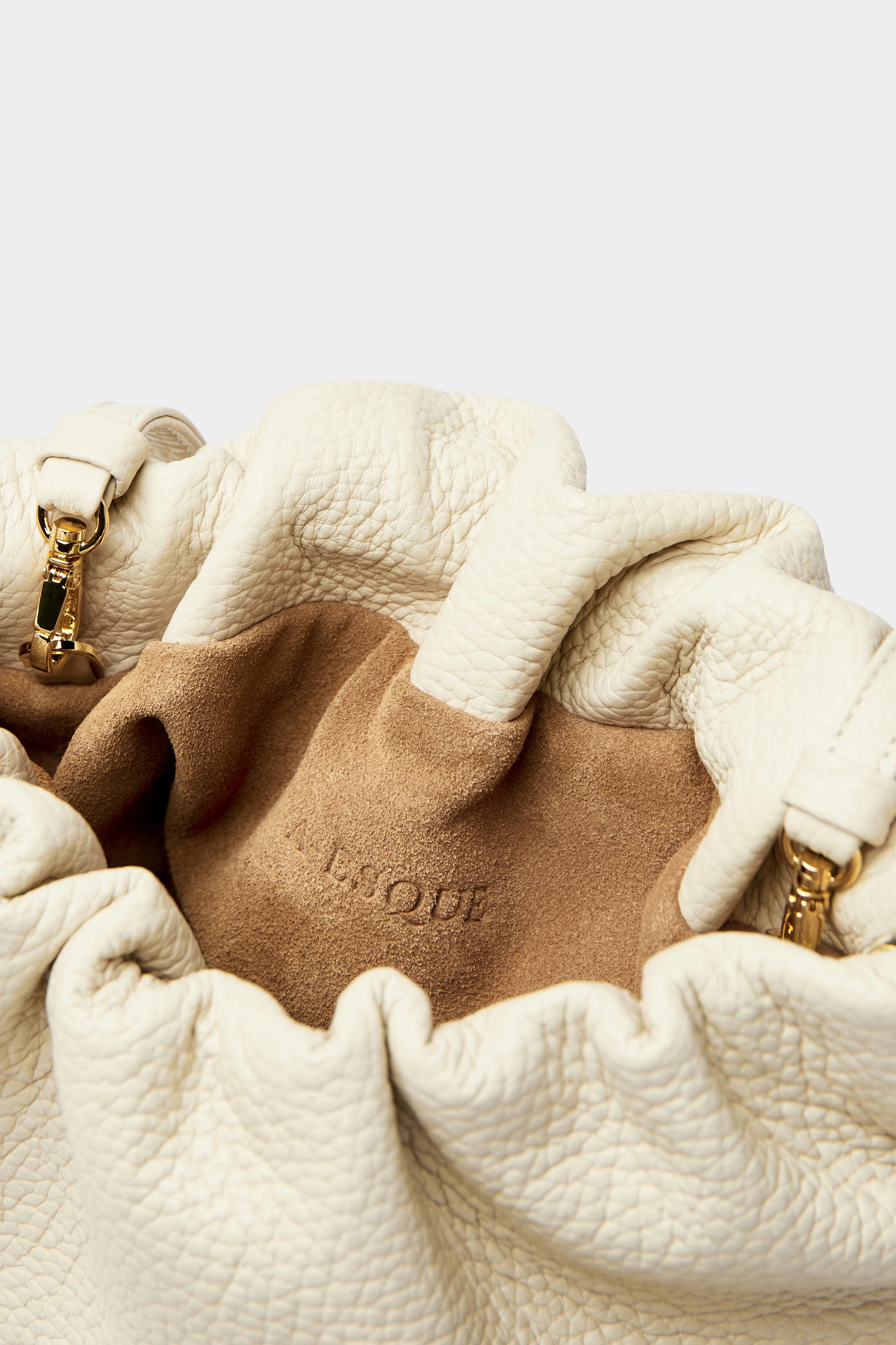 Mini Puffa crossbody bag has a suede interior lining with an A-esque logo stamped in the middle.