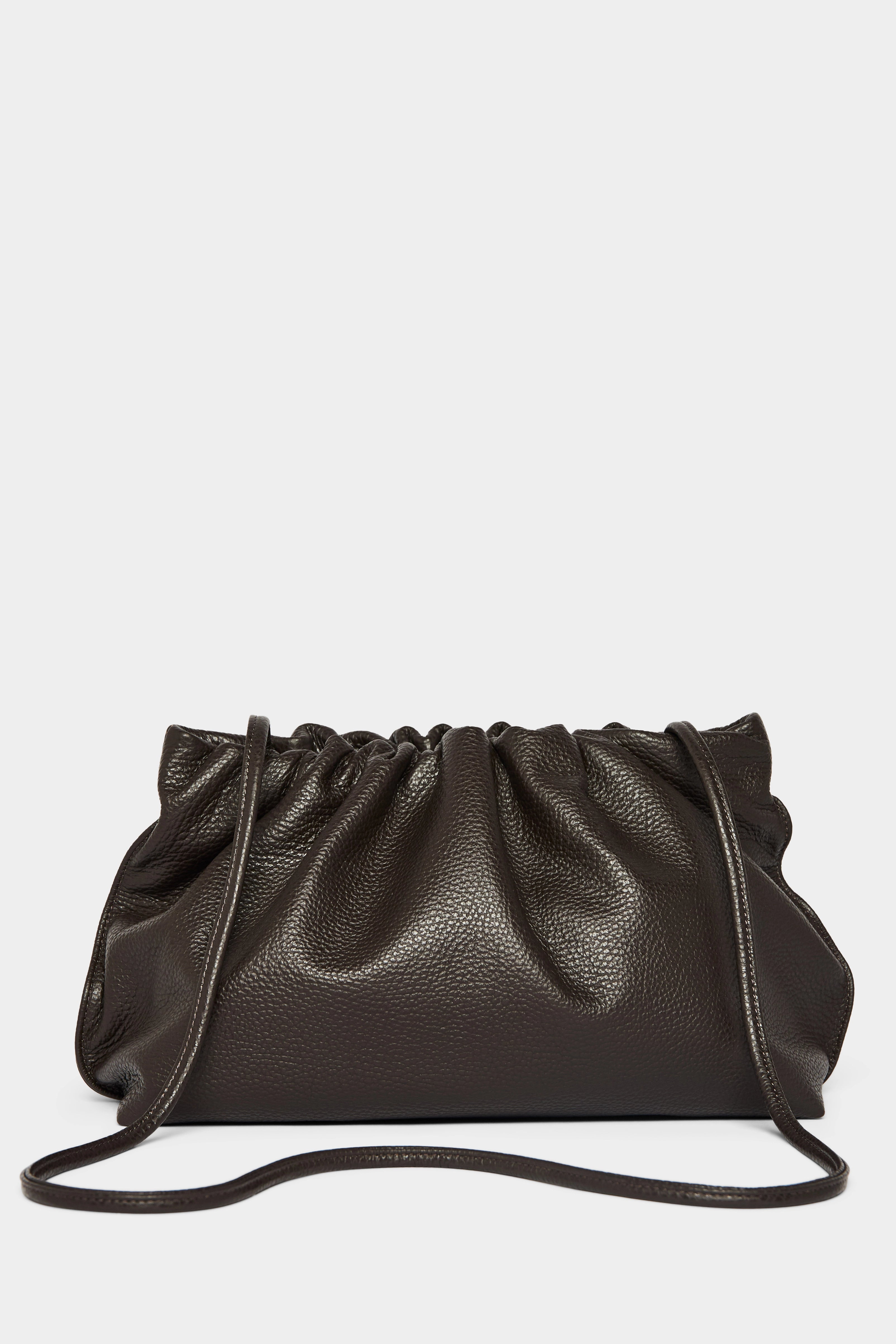 A dark brown clutch bag with a long removable shoulder strap. The handbag can also be worn handheld or a crossbody bag.