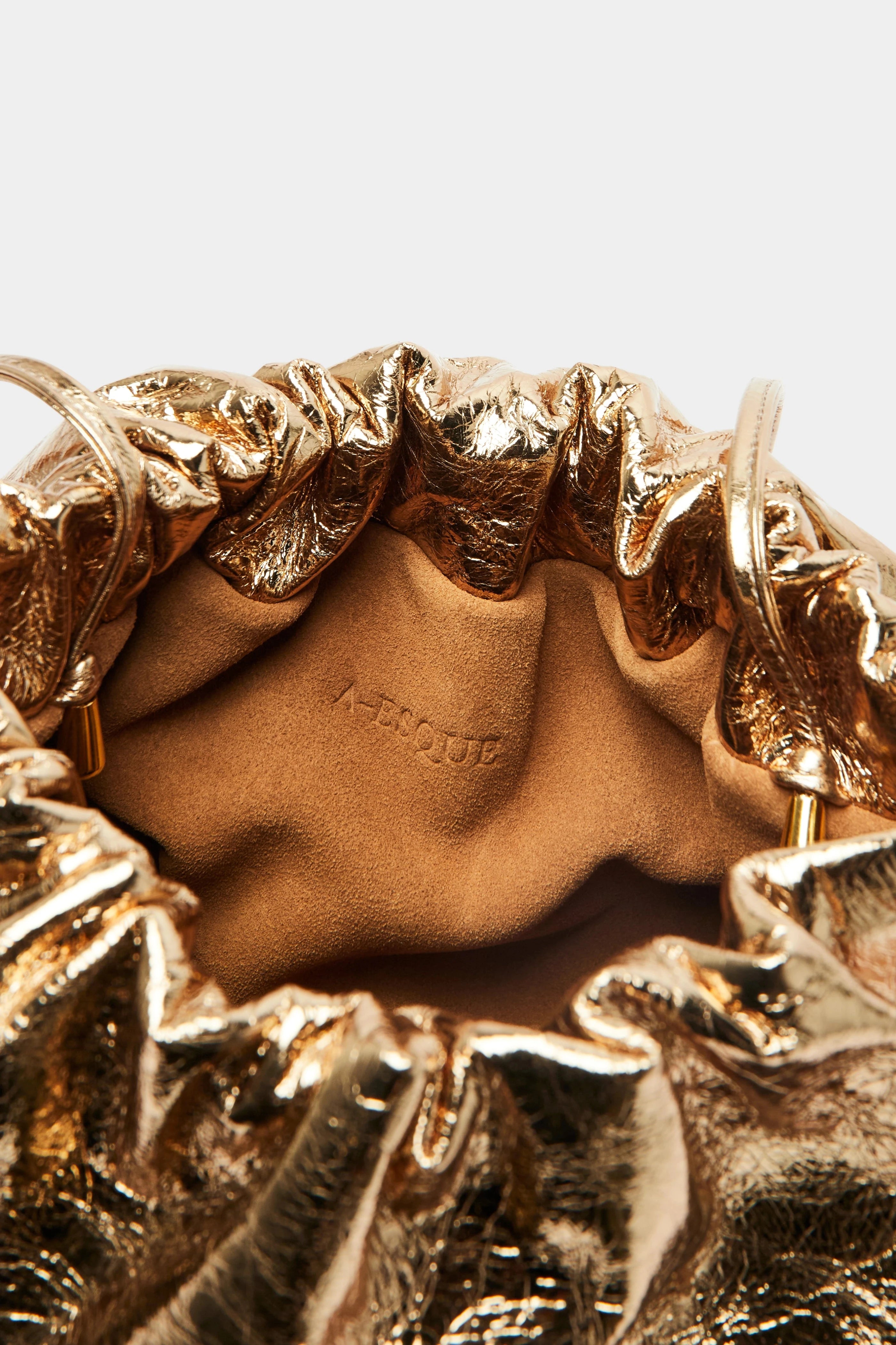 Puffa clutch crossbody bag has a suede interior lining with an A-esque logo stamped in the middle.