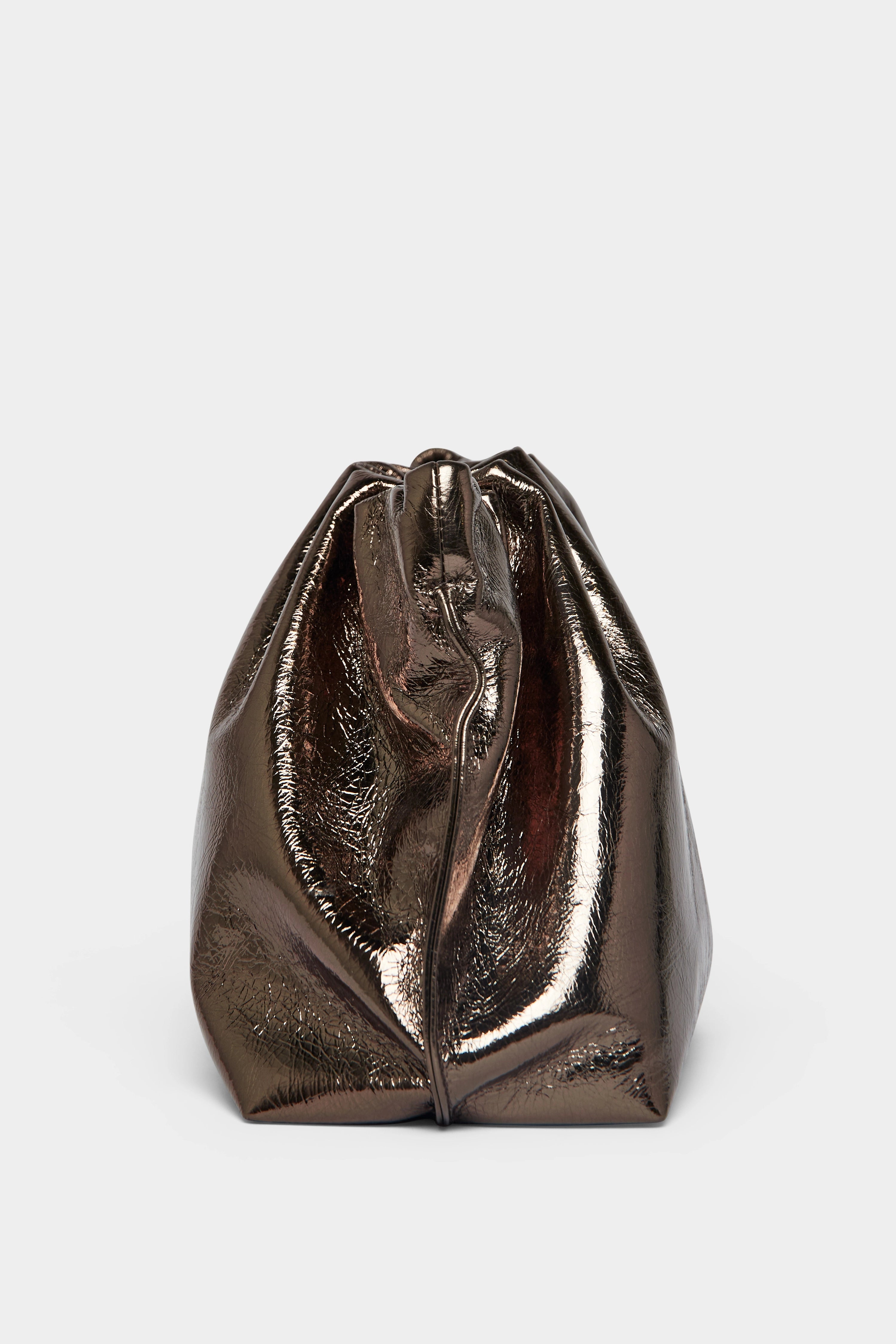 A side angle of the Puffa clutch purse featuring a delicate hand stitching of the mini bag's sides.