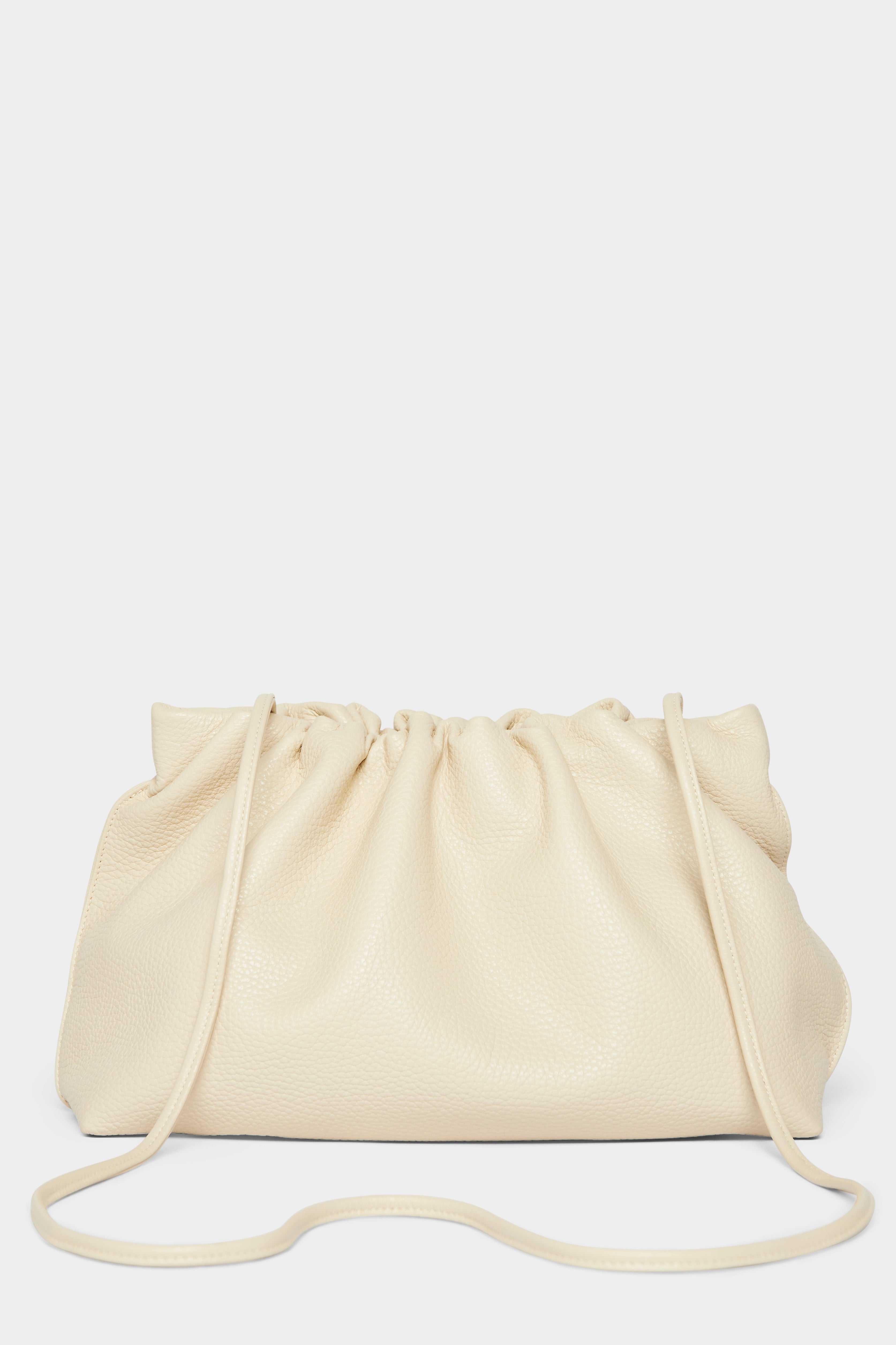 A white clutch bag with a long removable shoulder strap. The handbag can also be worn handheld or a crossbody bag.