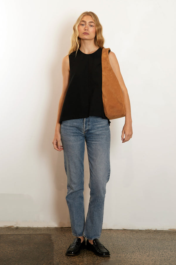 A woman carrying the halo day suede shoulder bag. The bag is large and great as a day bag.