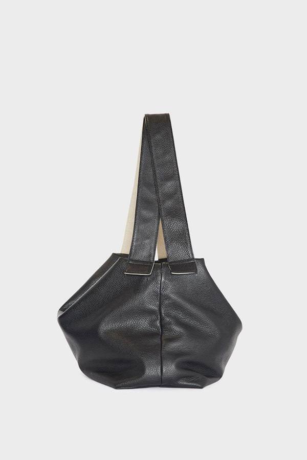 A side image of the Big Day shoulder bag featuring its two long handles and fine stitching. 