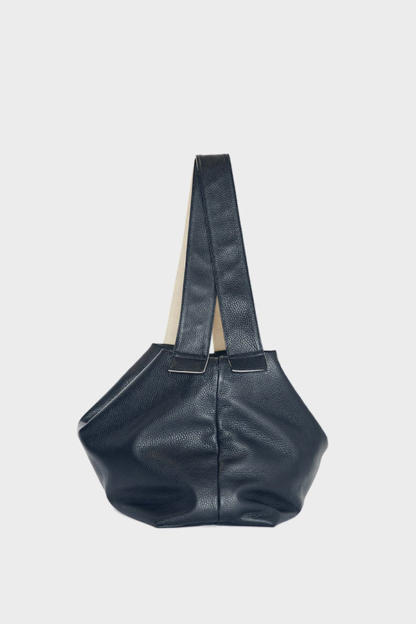 A side image of the Big Day shoulder bag featuring its two long handles and fine stitching.