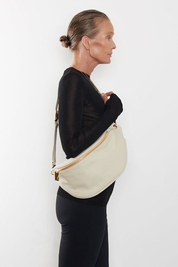 A woman wearing the Creators Crescent bum bag slung across her shoulder.