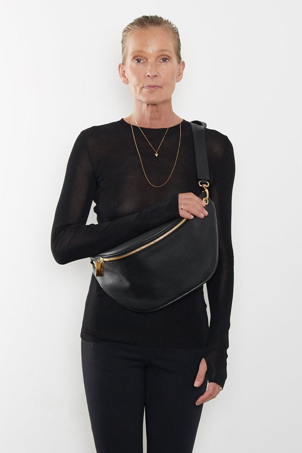 The Creators Crescent worn as a crossbody bag. The long detachable strap allows the bum bag to be worn in different ways.