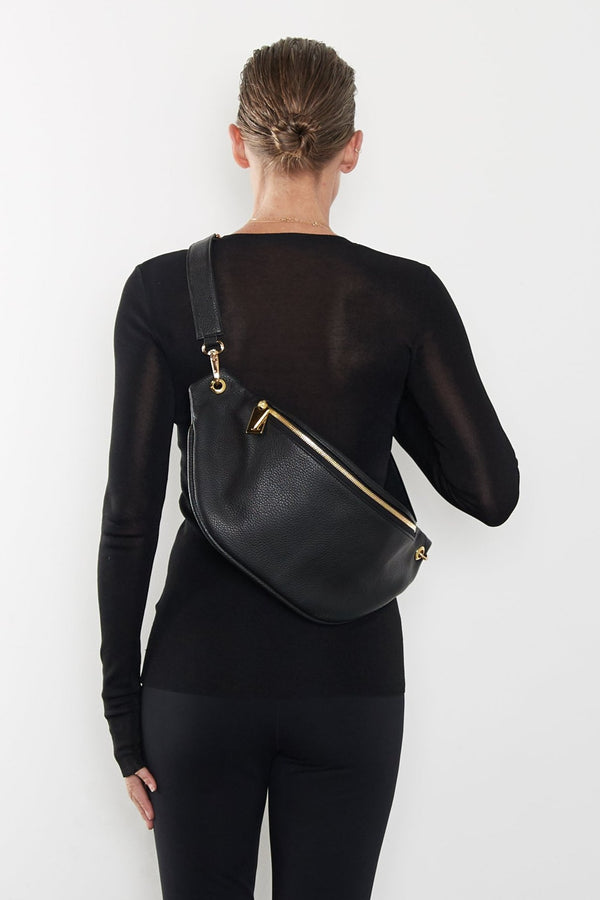 A woman wearing the Creators Crescent bum bag slung across her shoulder.