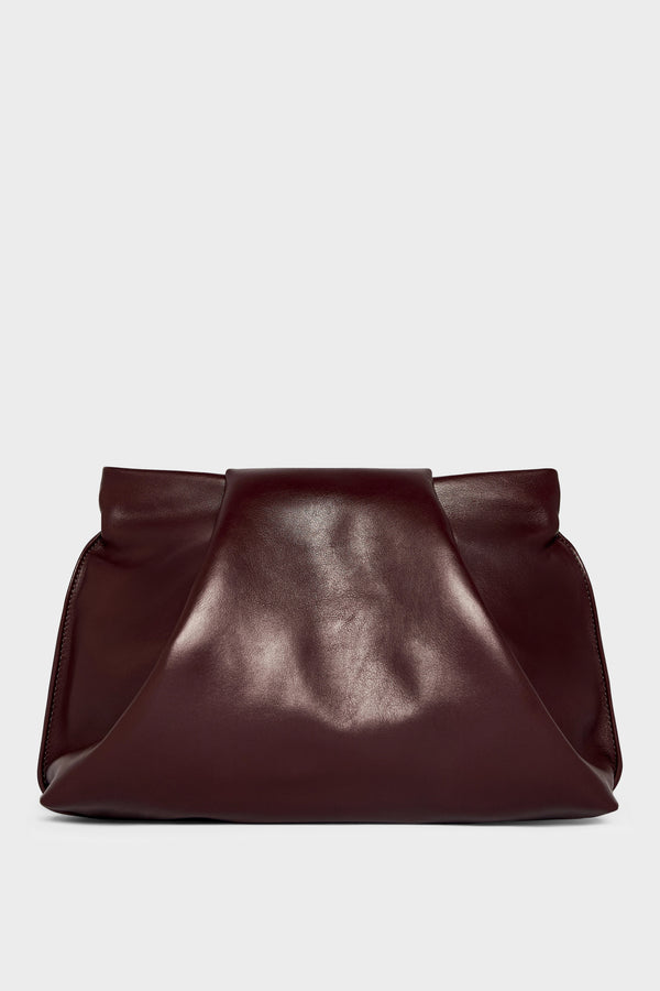 A black clutch bag made of smooth Italian leather. The handbag has removable strap and can also be worn as a shoulder bag. 