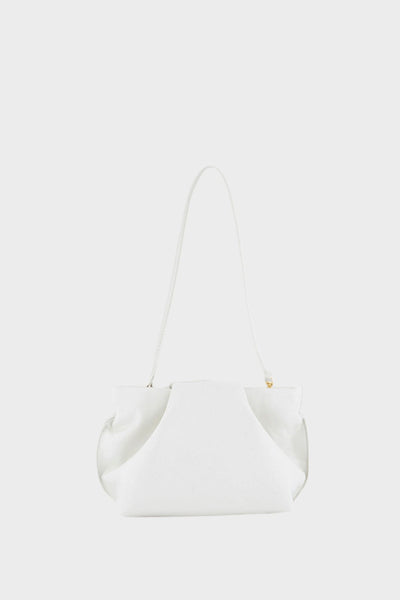 A photo of the white fold mini clutch bag with its handles up. It functions both as   as a shoulder bag and a clutch or purse.