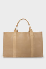 A large beige tote bag with a rectangular body and a magnetic closure. The bag has 2 handles to be carried handheld or as a shoulder bag.