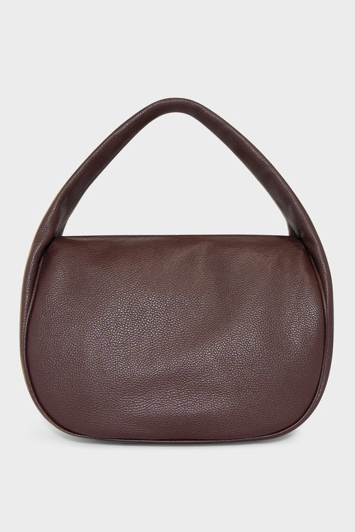 A large burgundy shoulder bag with a hobo inspired design made of fine Italian grain leather.