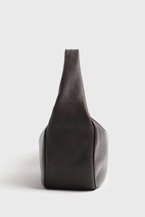 A side image of halo day shoulder bag featuring its slightly wide structured body and fine hand stitching.