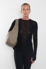 A woman carrying the halo day shoulder bag. The bag is large and great as a day bag. 