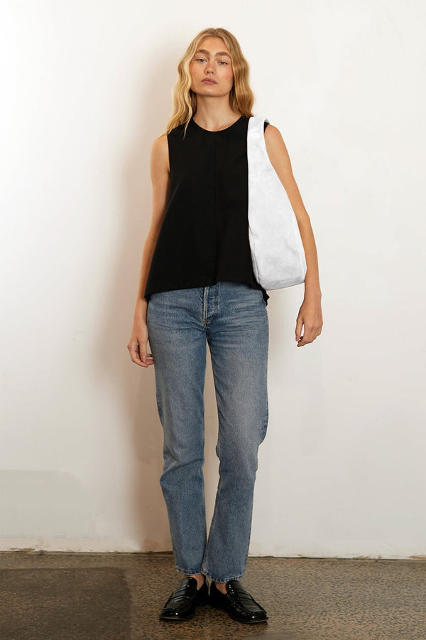 A woman carrying the halo day shoulder bag. The bag is large and great as a day bag.