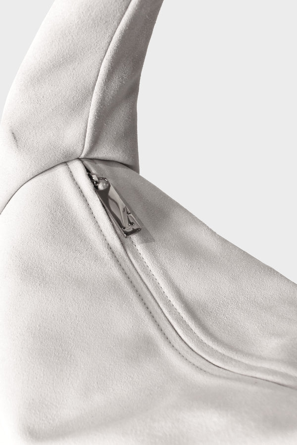 Halo Day suede shoulder bag in white features a silver hardware and zipper with fine hand stitching.