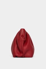 A side angle of the mini Puffa clutch purse featuring a delicate hand stitching of the mini bag's sides. 