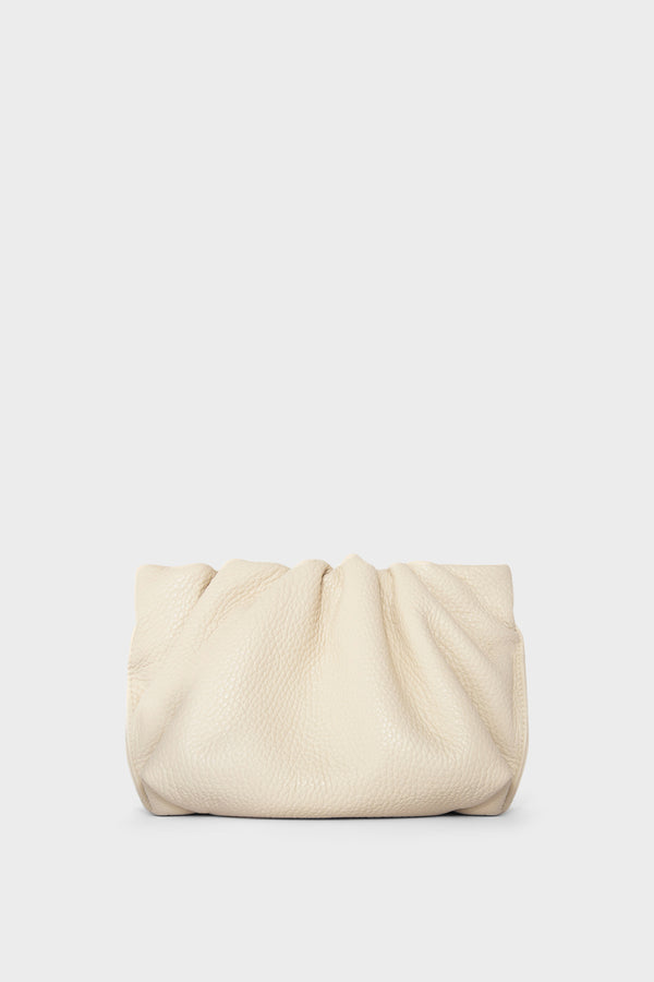 A white mini clutch bag made of grain Italian leather. This mini bag has a long removable strap and can also be worn as a crossbody bag.