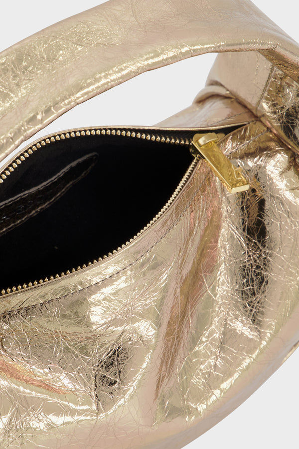 The metallic gold halo bag features gold hardware and durable zippers with the initial “A” engraved for A-esque.