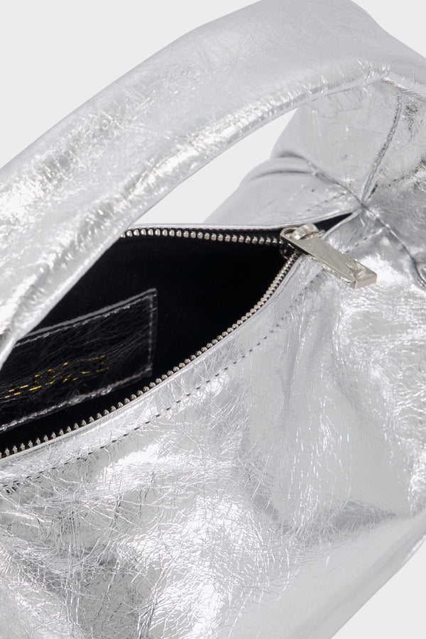 The metallic silver mini halo bag features a silver hardware and a durable zipper with the initial “A” engraved for A-esque.