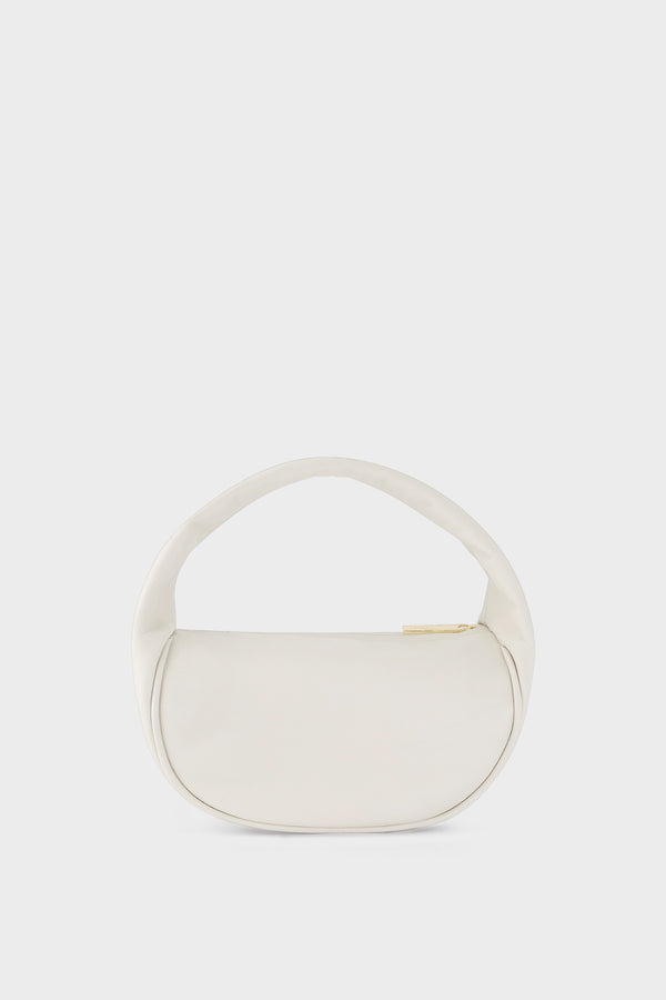 A white mini bag. This handbag is similar to a clutch but with one handle connecting its body. It’s made of smooth Italian leather.