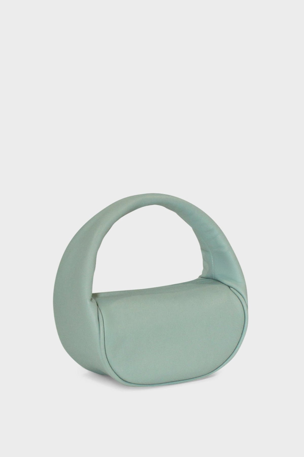 A side image of the mini halo bag in pastel green.  This handbag has a clutch like design and can be worn handheld or on the crook of the arm suited as a party or evening purse.