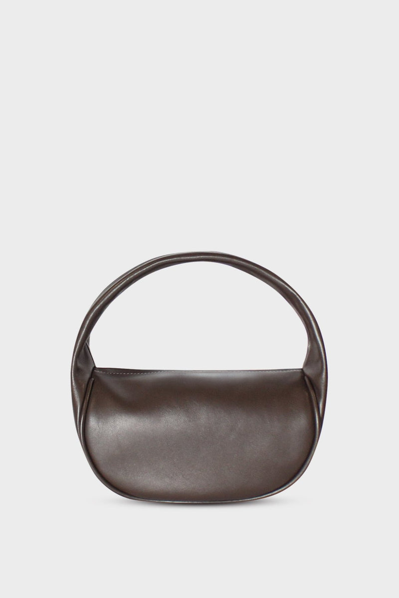 A dark brown handbag made of fine smooth Italian leather. This mini bag is carried handheld or on the crook of the arm. The bag can be used as a clutch or a purse suited for parties or as an evening bag. It's called Mini Halo Bag in Smooth Dark Brown