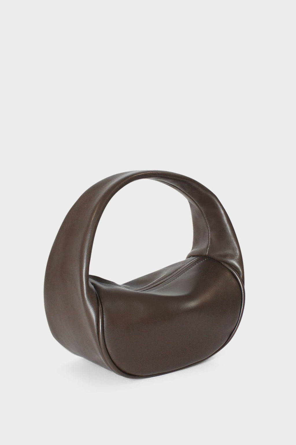 A side image of the mini halo bag in dark brown.  This handbag has a clutch like design and can be worn handheld or on the crook of the arm suited as a party or evening purse.