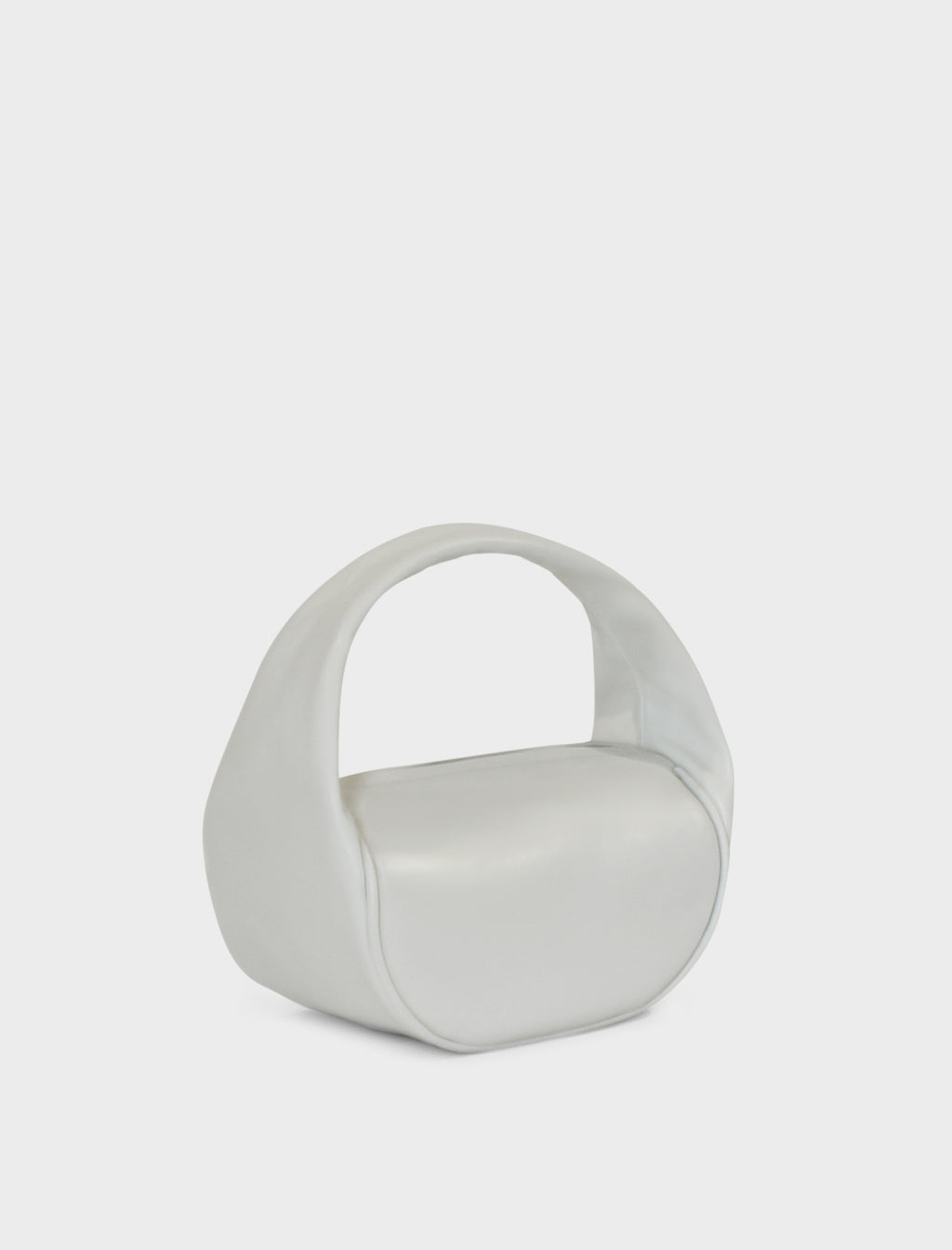 A side image of the mini halo bag in off white.  This handbag has a clutch like design and can be worn handheld or on the crook of the arm suited as a party or evening purse.