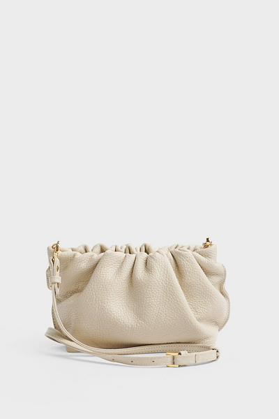 A white mini clutch bag made of smooth Italian leather.with a long removable and adjustable strap for crossbody wearing.