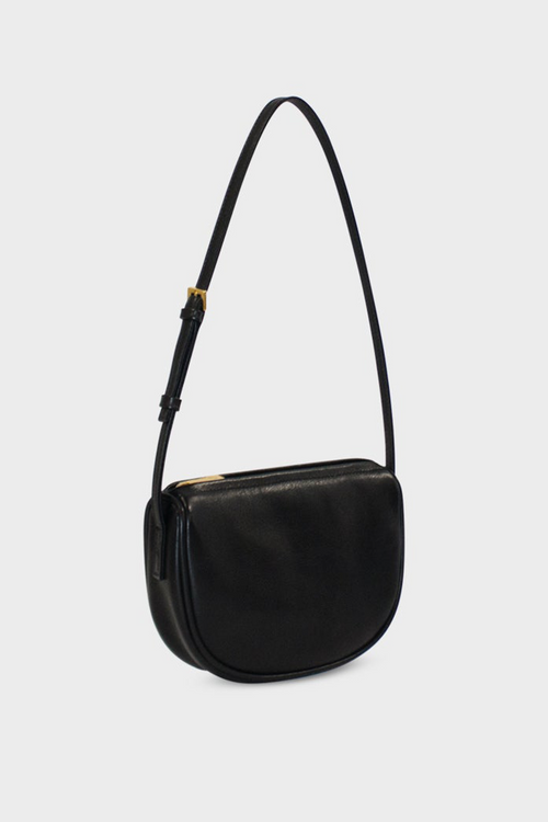 The side angle of the mini saddle shoulder bag features a structured and slim body.