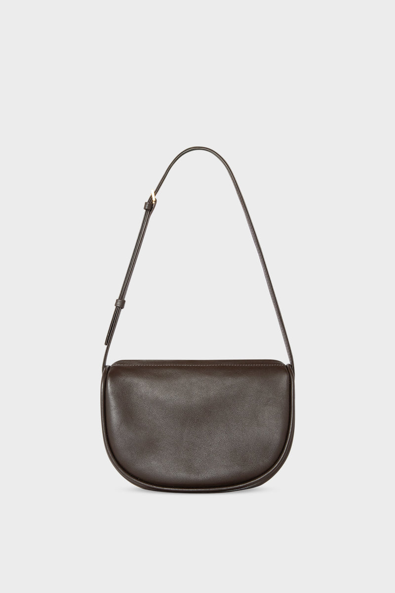 A mini shoulder bag in dark brown made of fine smooth Italian leather. The handbag follows a hobo design with an adjustable shoulder strap.