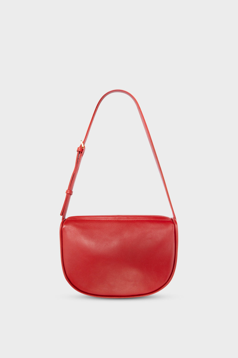 A mini shoulder bag in red made of fine smooth Italian leather. The handbag follows a hobo design with an adjustable shoulder strap.