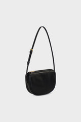 A side image of a shoulder bag in the color black. The mini bag  follows a saddle like design with a slim body. The bag is called Mini Saddle Shoulder Bag in Smooth Black.