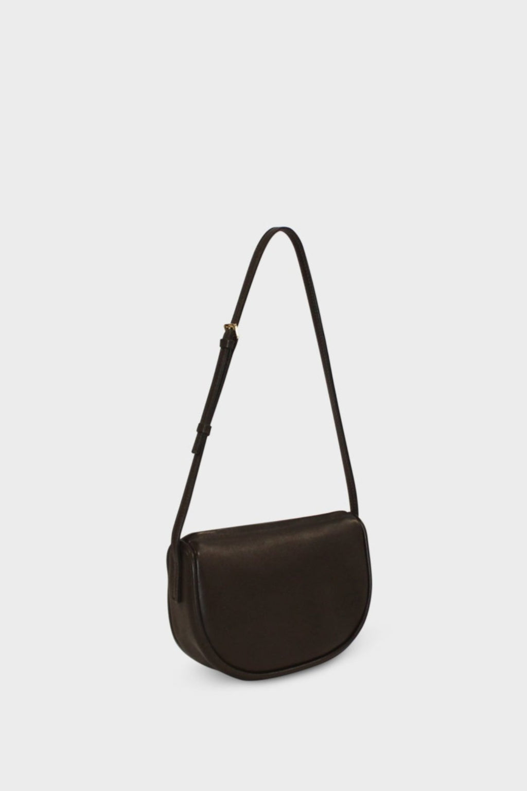 A side image of a shoulder bag in the color dark brown. The mini bag  follows a saddle like design with a slim body. The bag is called Mini Saddle Shoulder Bag in Smooth Dark Brown.