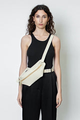 The Oblong Bum Bag worn as a crossbody bag. The belt bag inspired design is suited as an add-on mini travel bag. 