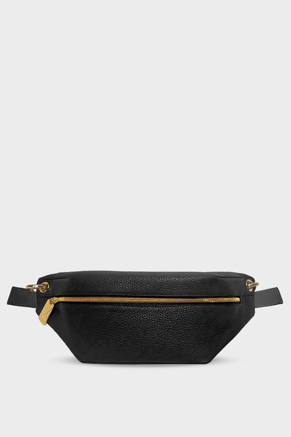 A black crossbody bag that also takes the form of a belt bag. It has a zip opening in gold hardware and is made of fine Italian grain leather. 