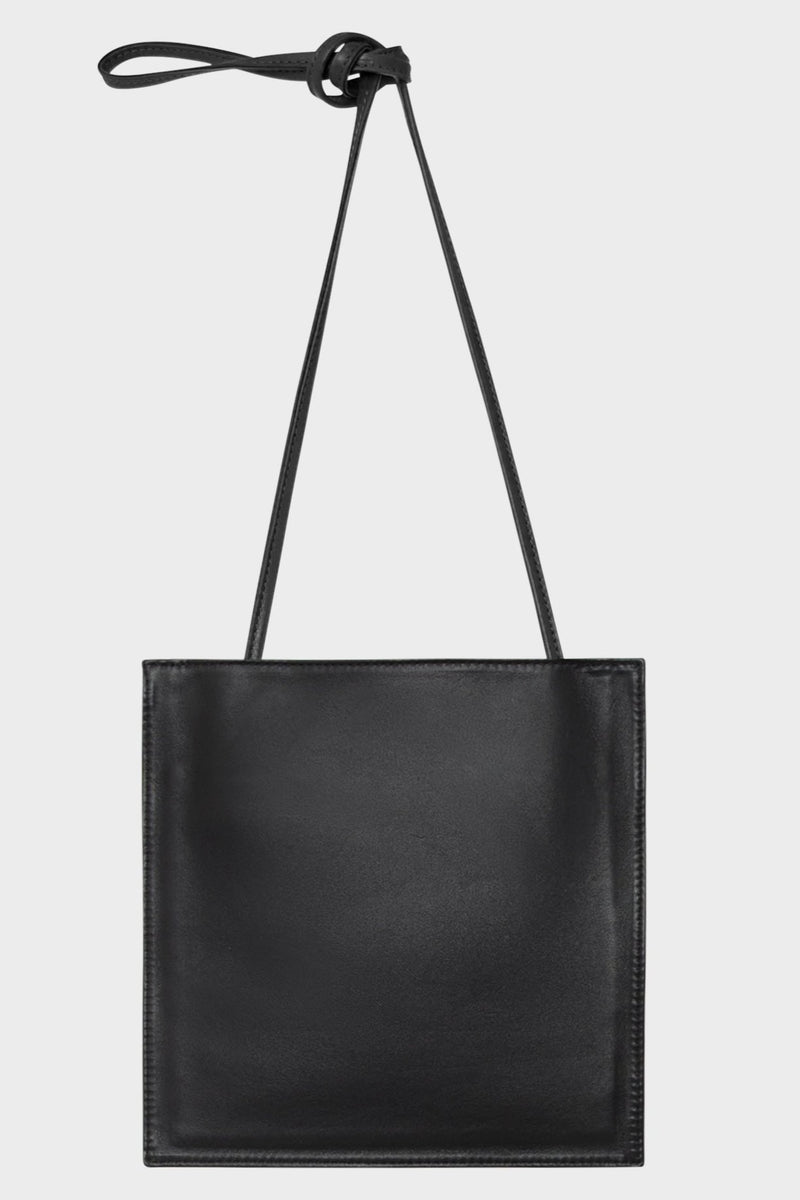 A black mini crossbody bag with a slim pouch design.