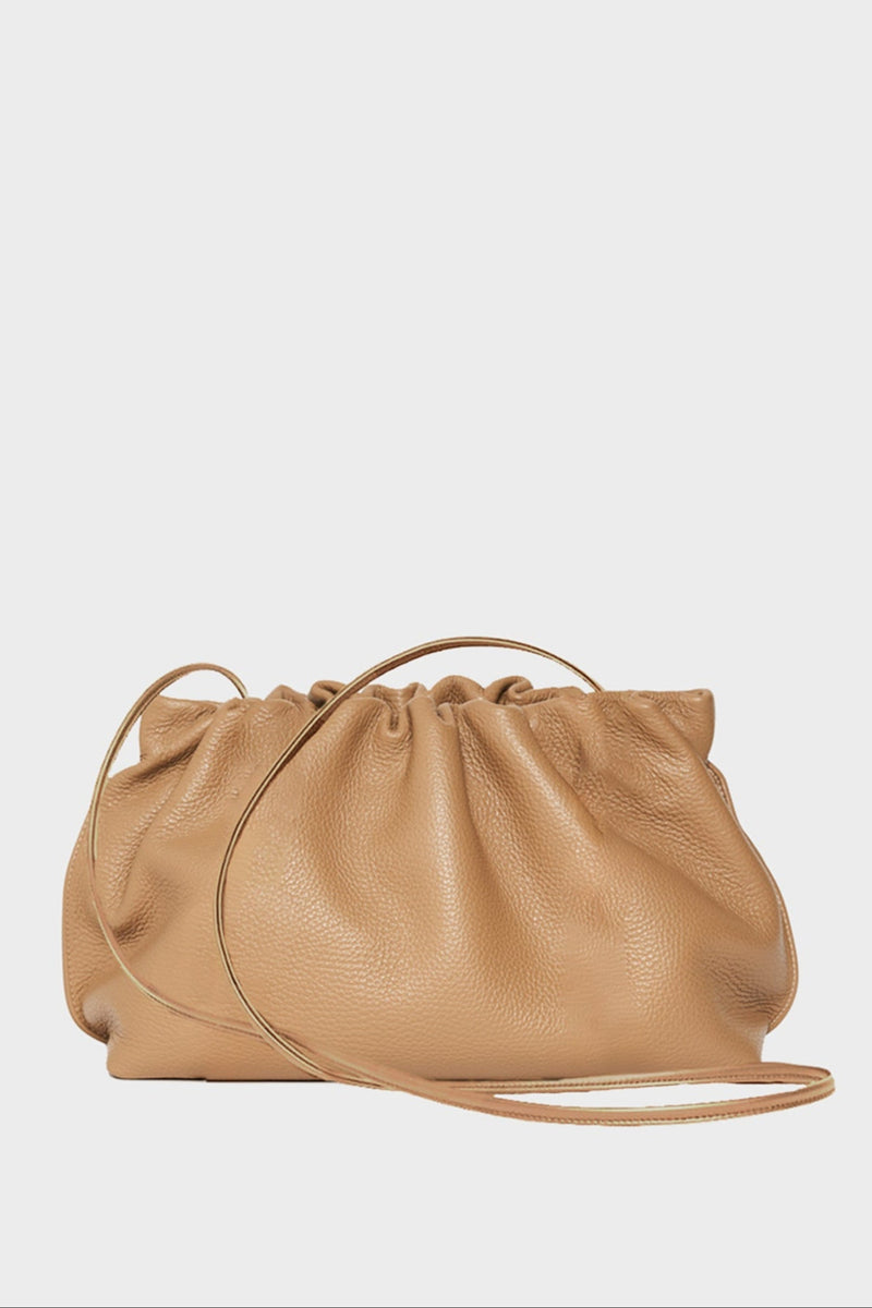 A beige clutch bag made of grain Italian leather. The handbag has a removable strap and can also be worn as a crossbody bag. 