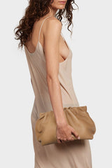A woman carrying the Puffa clutch bag. This handbag has a modern design suited as a party clutch purse. 