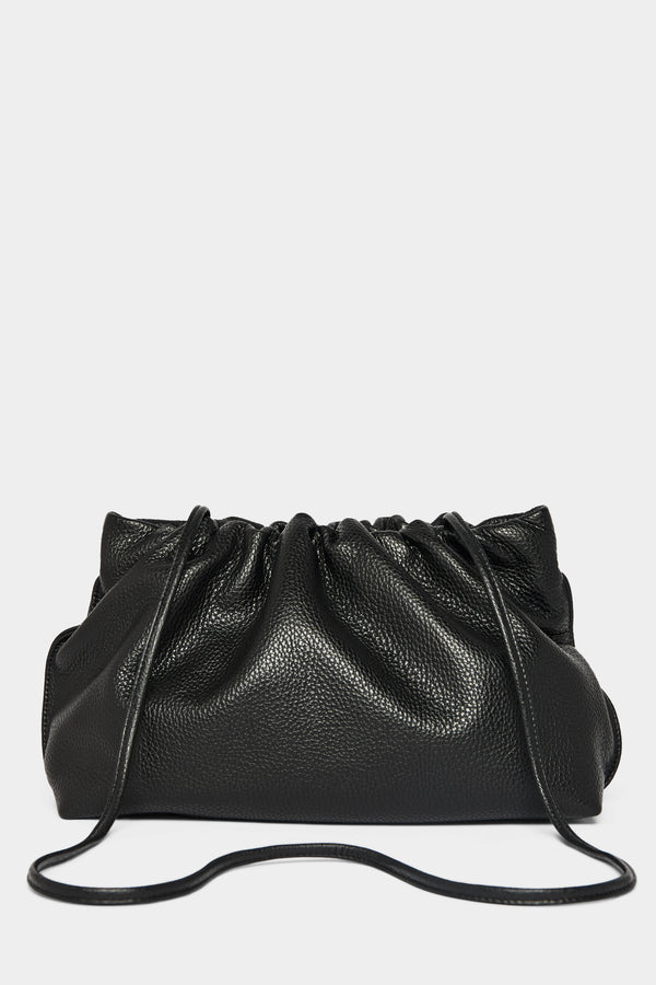 A black clutch bag with a long removable shoulder strap. The handbag can also be worn handheld or a crossbody bag. 